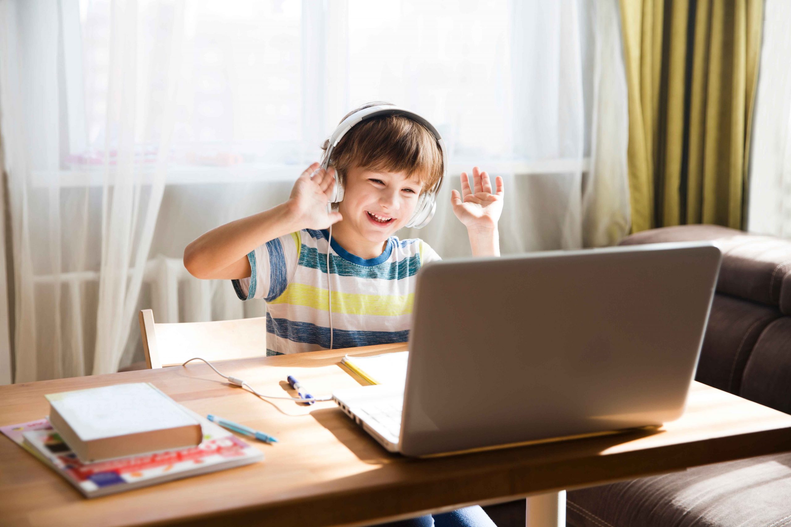 Child,Boy,In,Headphones,Is,Using,A,Laptop,And,Study